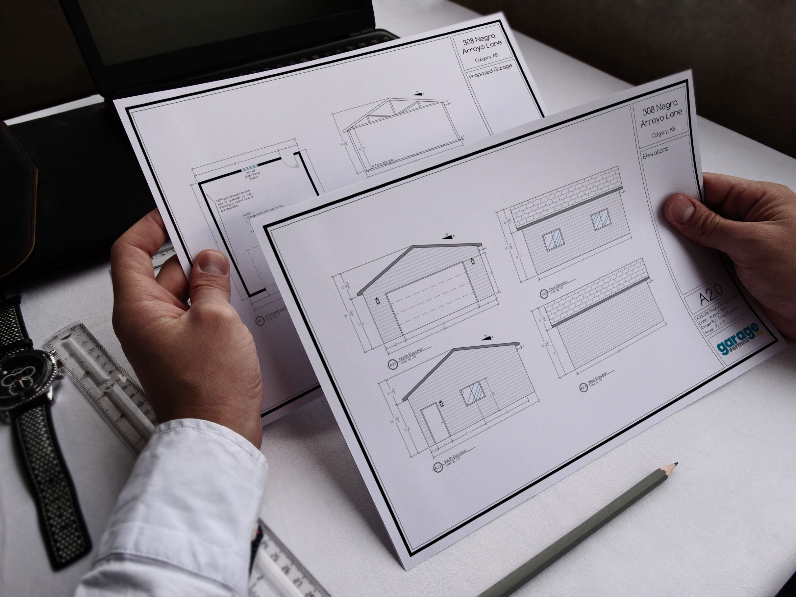 Garage permit drawings being reviewed on a desk